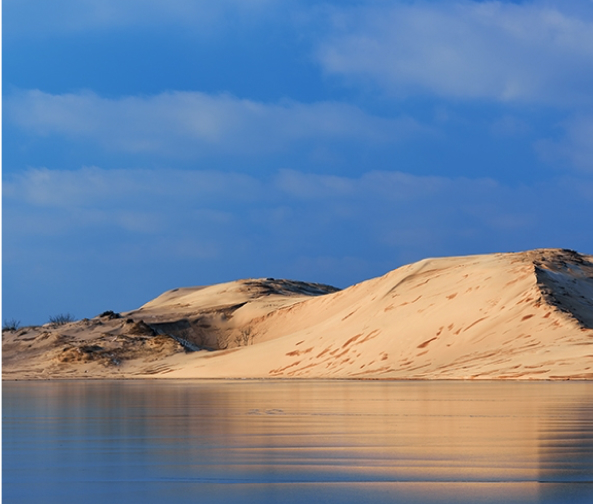 Sand dunes and water