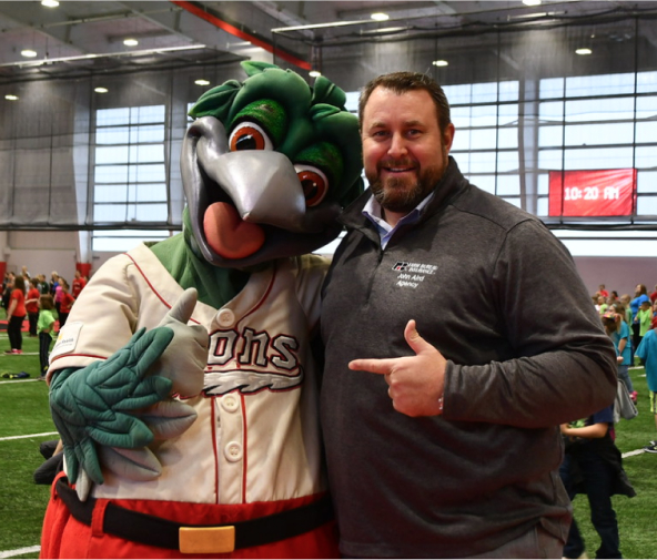 Saginaw, Michigan agent John Aird, attends ACES Day with Lou E. Loon. The Great Lakes Loons mascot.